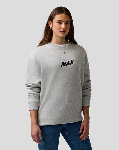 Person wearing a gray sweatshirt with 'MAX' printed on it against a plain background