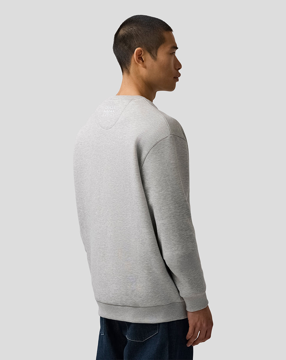 Person wearing a gray sweatshirt against a plain background