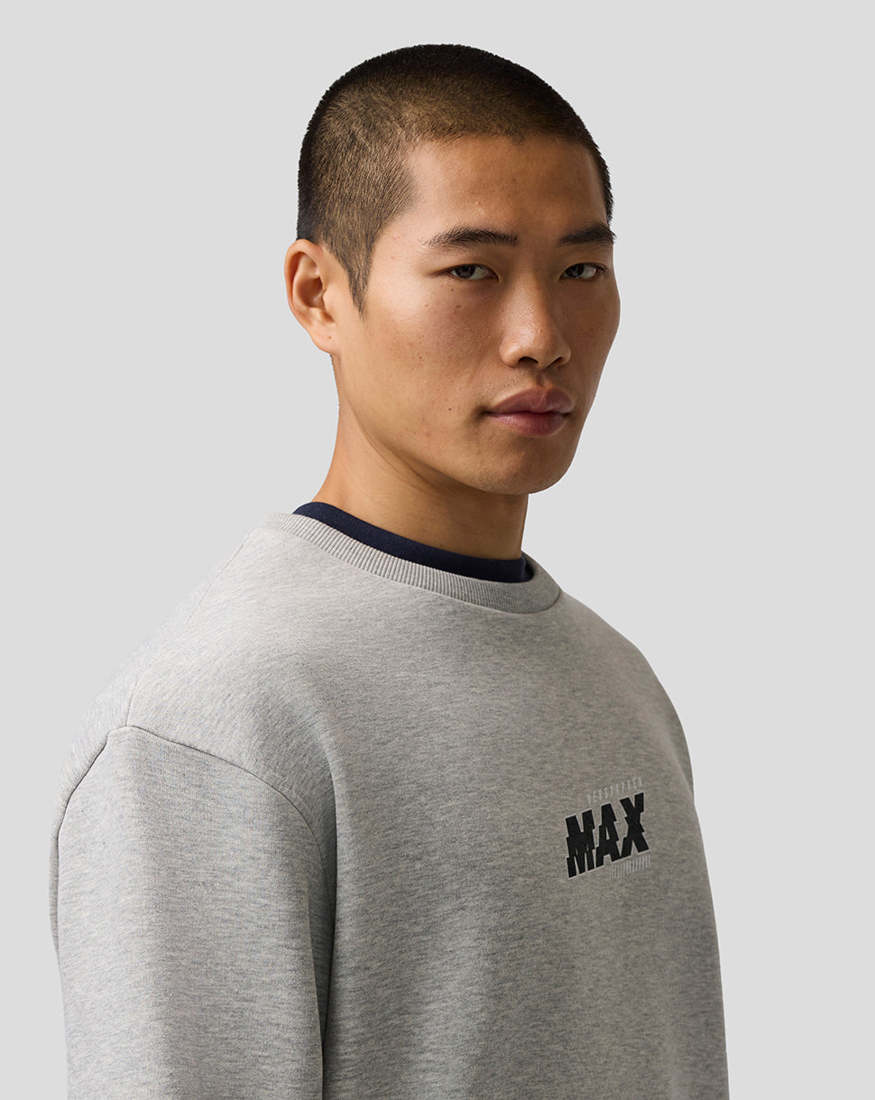 Man wearing a gray sweatshirt with 'MAX' logo on a light gray background