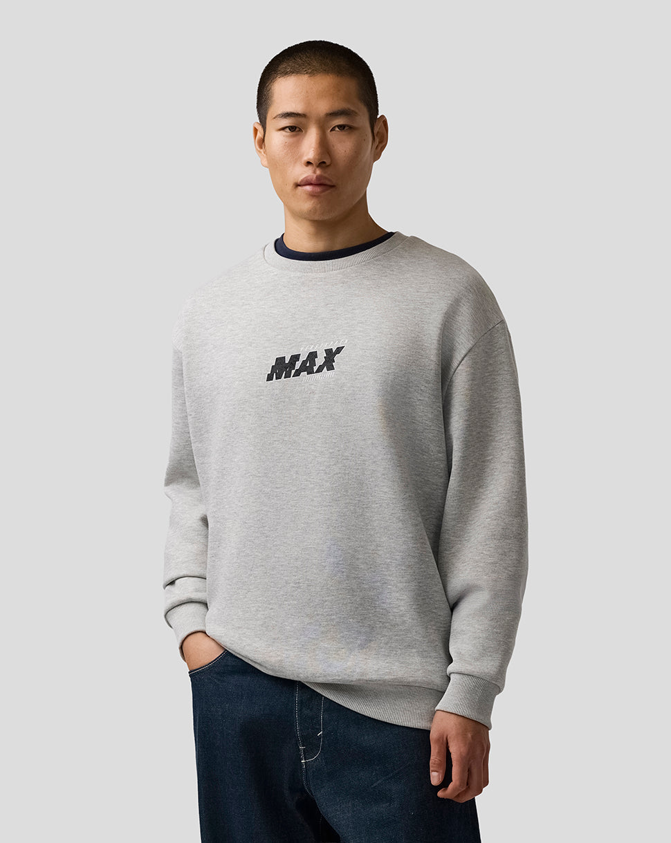 Man wearing a gray sweatshirt with 'MAX' text on a plain background