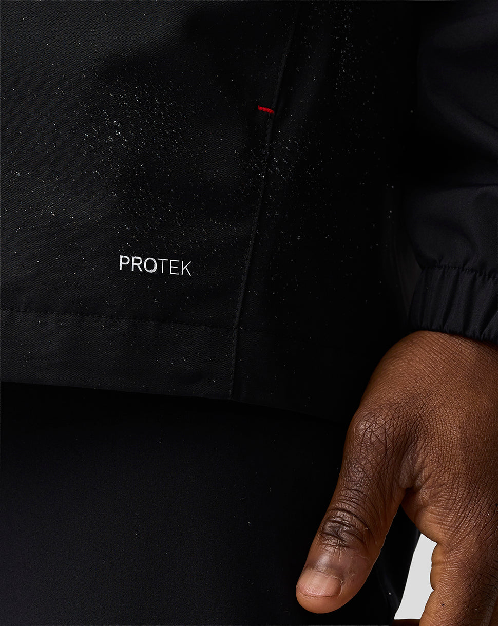 Black jacket with 'PROTEK' branding on a dark background