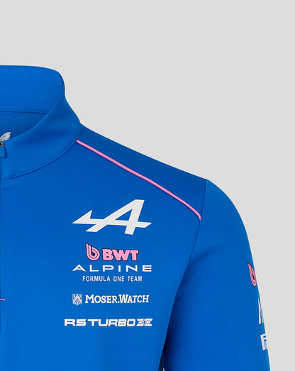 Close up of blue Official Unisex BWT Alpine Formula One Team Quarter Zip Midlayer with pink piping along the shoulder and chest sponsor logos.