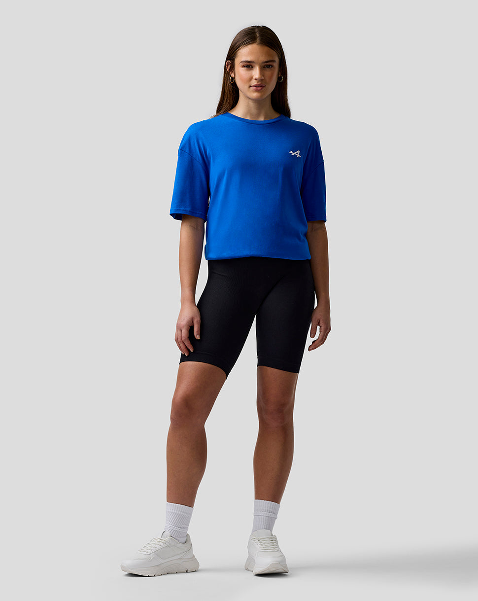 Model wearing lapis blue unisex relaxed fit T shirt with embroidered A logo on the left chest