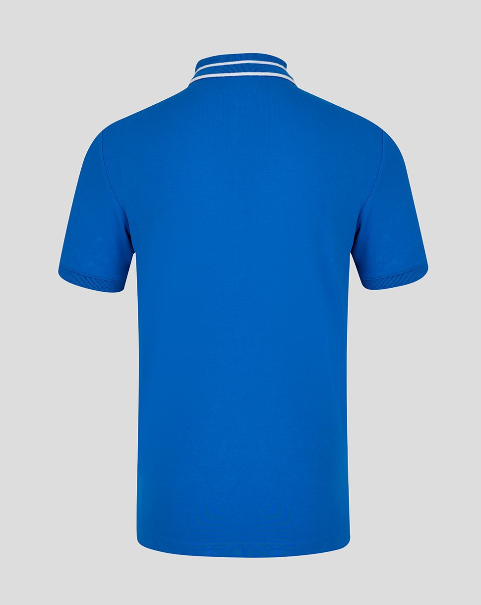 Back view of blue BWT Alpine polo with a double striped collar and A logo embroidered on the sleeve.