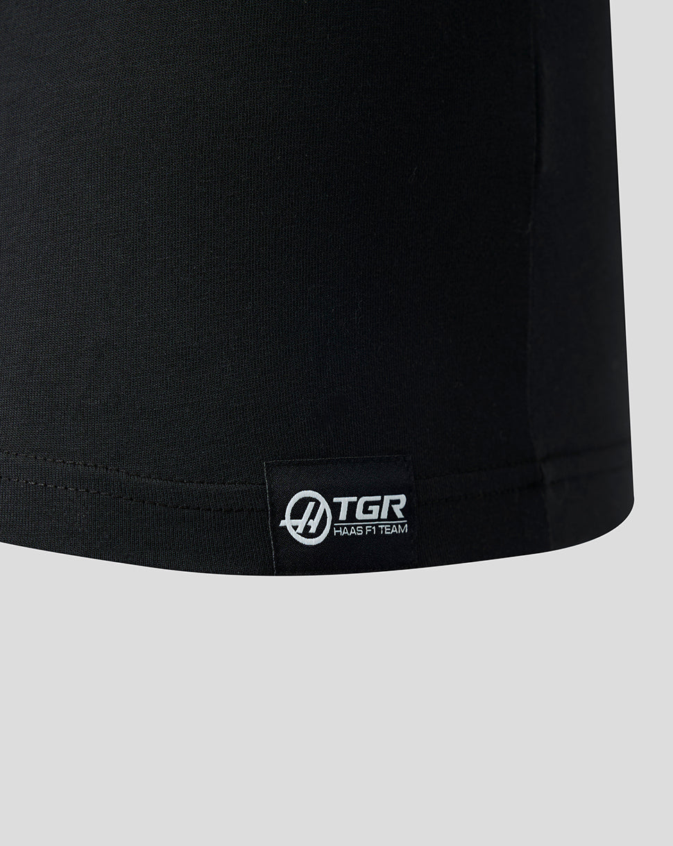 Black t-shirt with a visible brand logo on a light gray background
