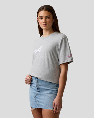 Female model wearing grey marl Alpine graphic T-shirt with chest print and pink sleeve logo.