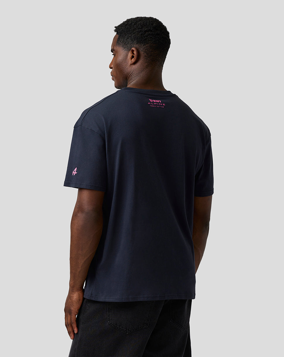 Male model shown from behind wearing navy relaxed fit graphic T shirt with pink branding on the upper back and sleeve