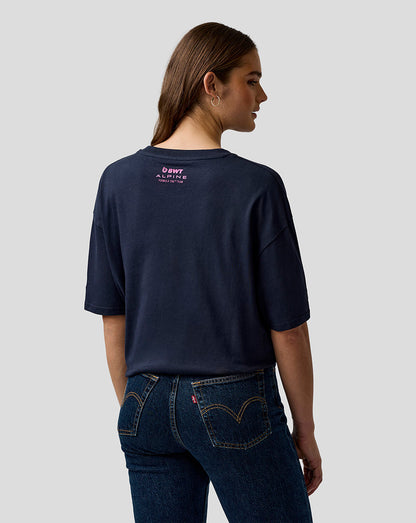 Back view of a model wearing a navy relaxed-fit T-shirt with a pink Alpine logo on the upper back.