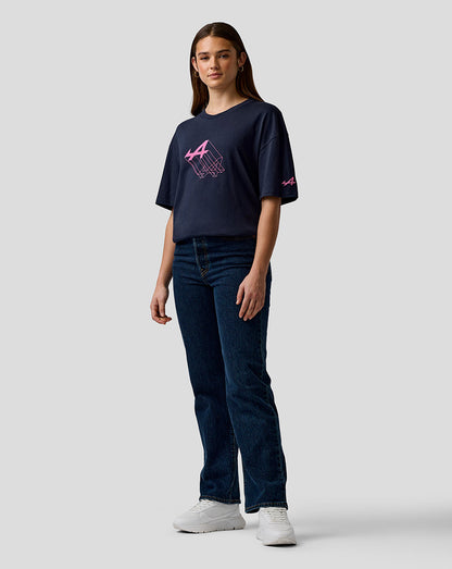 Front view of a woman wearing a navy relaxed-fit graphic T-shirt with a pink Alpine logo on the chest and sleeve.