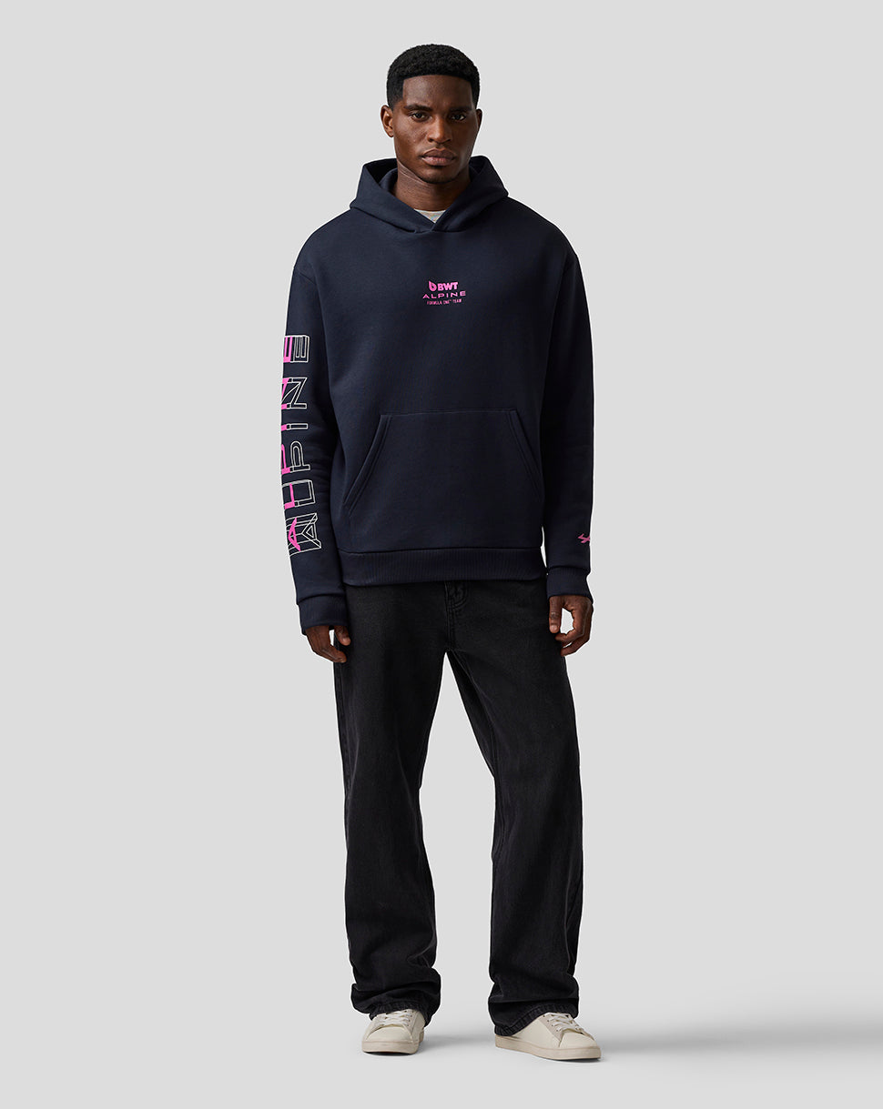 Male model wearing navy BWT Alpine graphic hoodie with pink chest logo and large sleeve graphic, front pocket and hood.