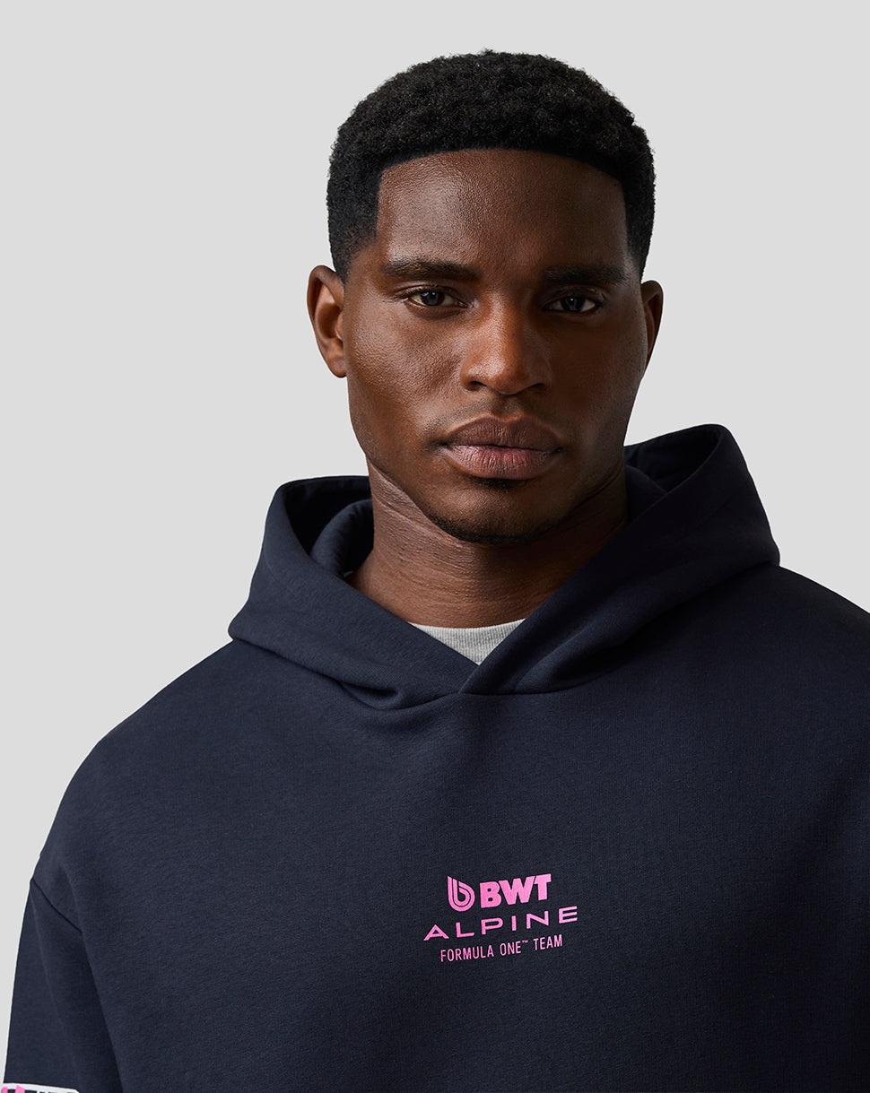 Close-up of navy hoodie chest area showing pink BWT Alpine branding.