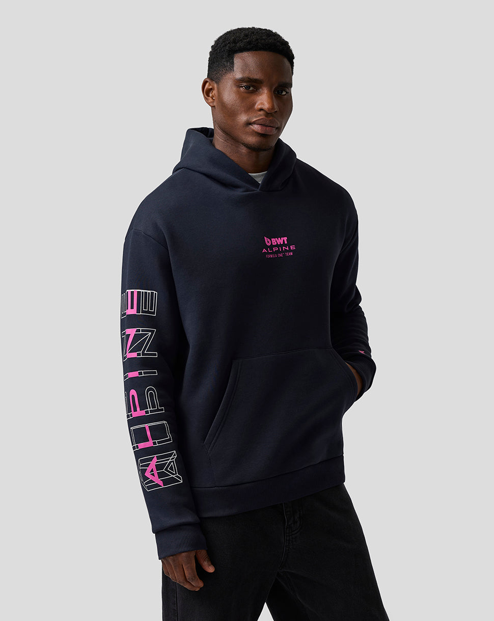 Man wearing navy Night Sky hoodie with pink Alpine chest logo.