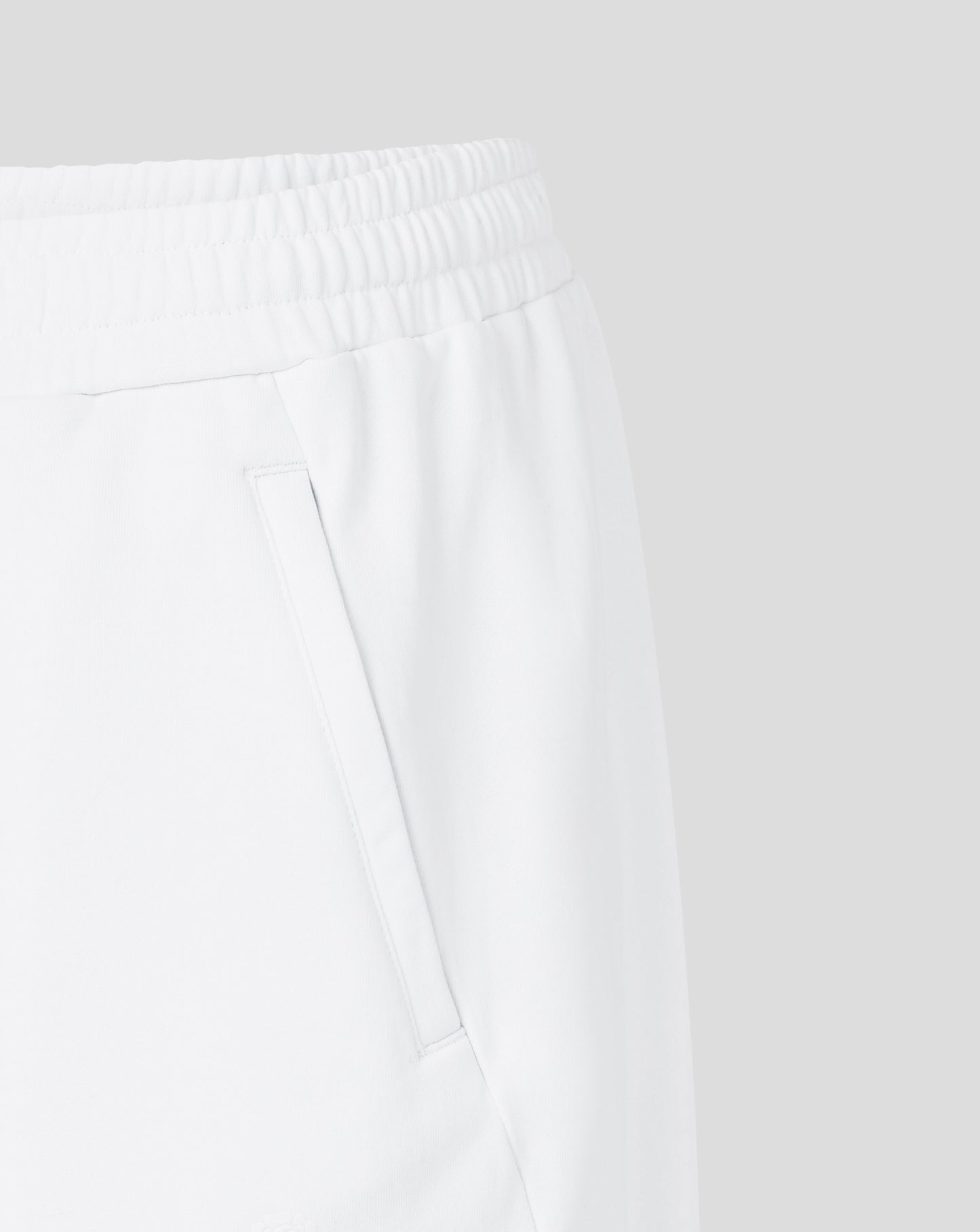 Close-up of white pants with a plain background