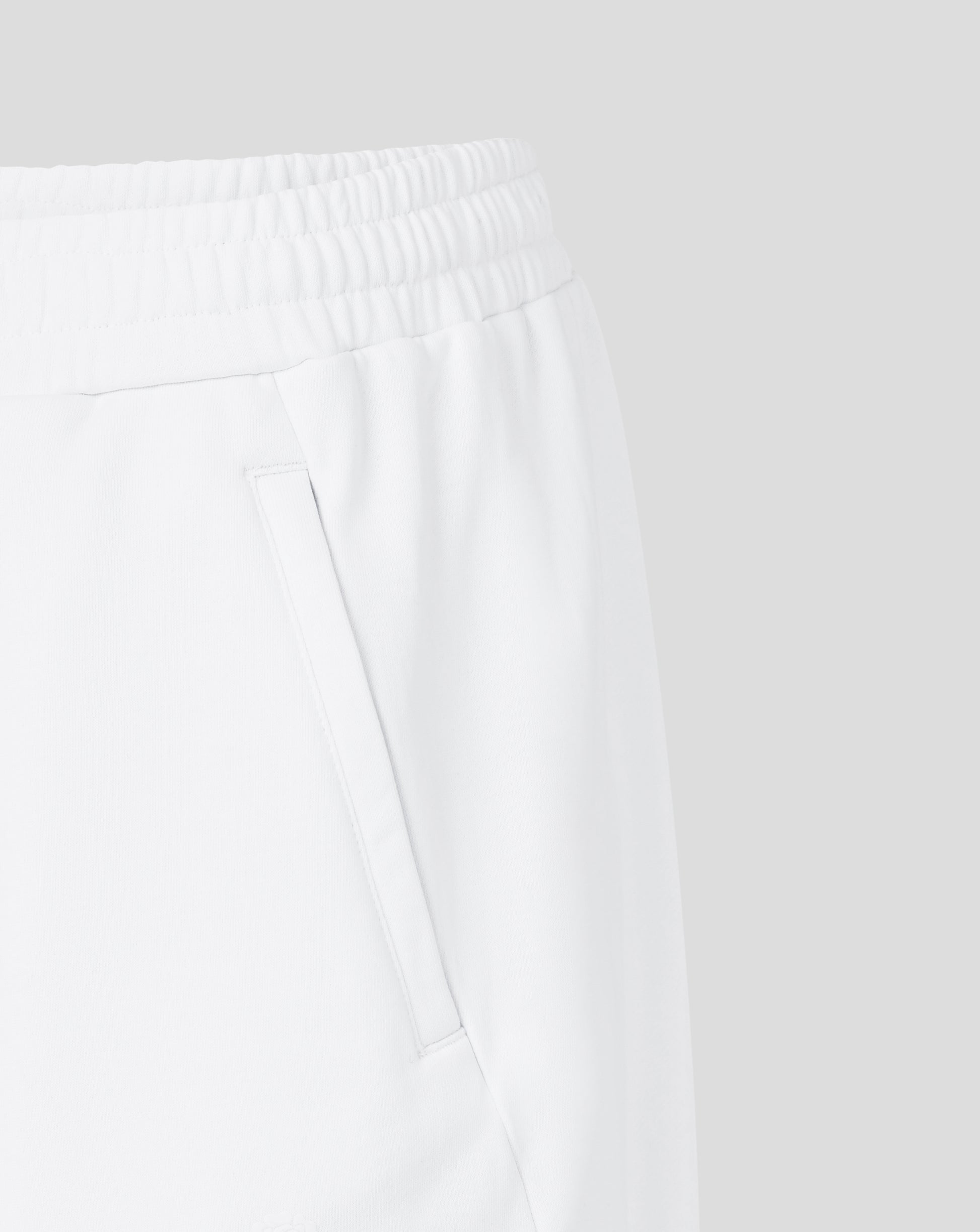 Close-up of white pants with a plain background