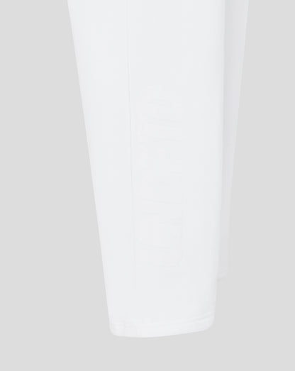 Close-up of white joggers on a light gray background