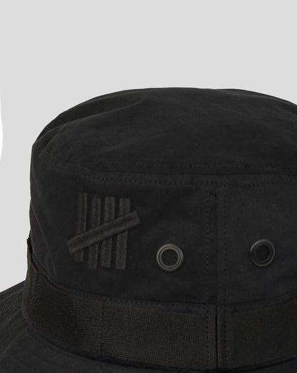 Black bucket hat with a brand logo on a light gray background
