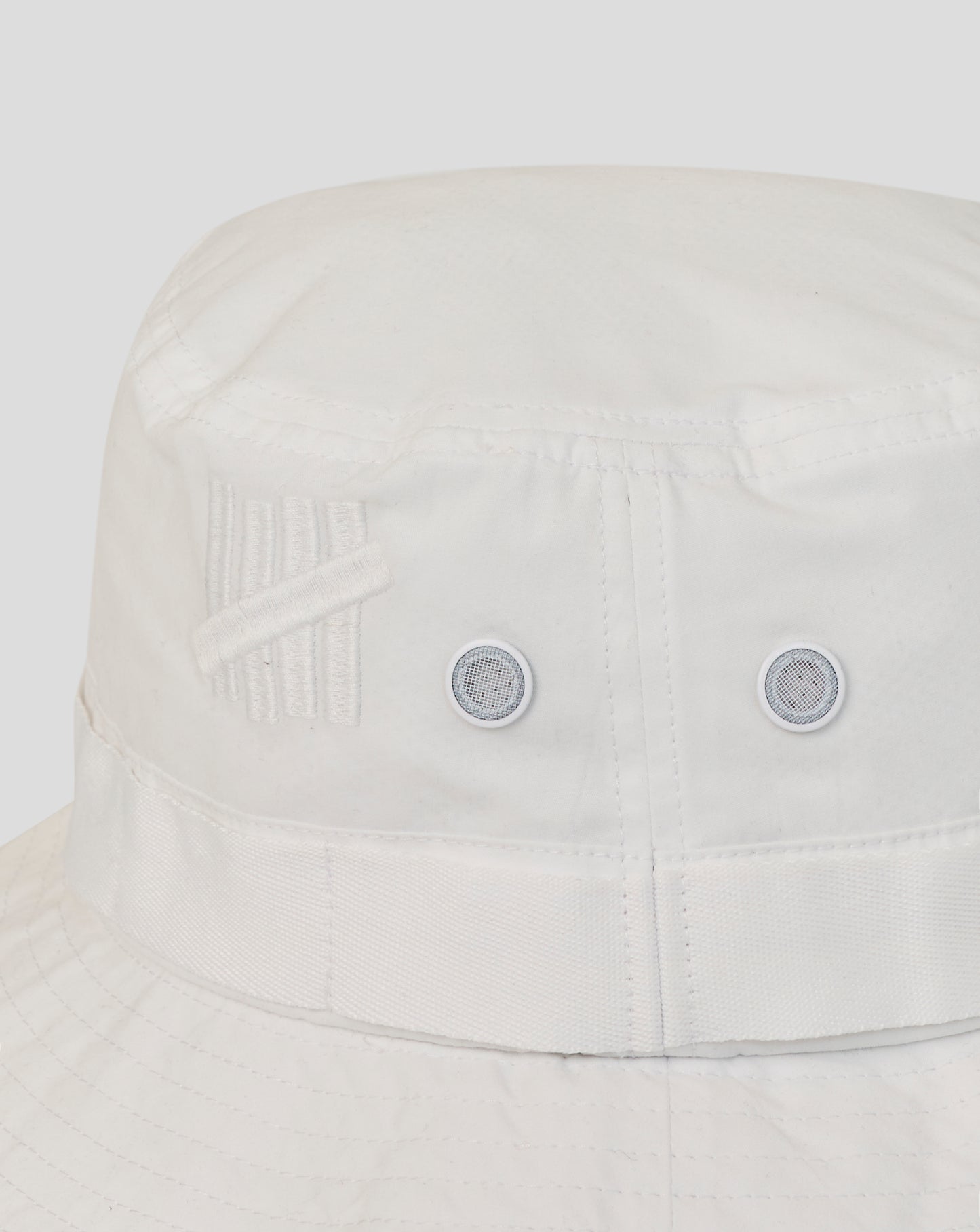 Light gray bucket hat with a subtle pattern on a light gray background