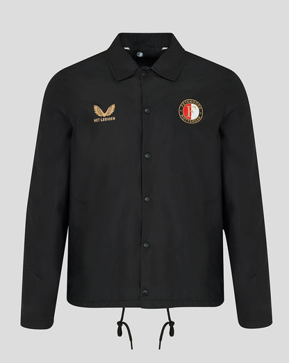 A black long-sleeve button-up jacket with a collar, featuring a gold embroidered winged logo and 'HET LAKEN' text on the right chest, and a circular red, white, and gold crest on the left chest. The jacket is displayed on a neutral light gray background.