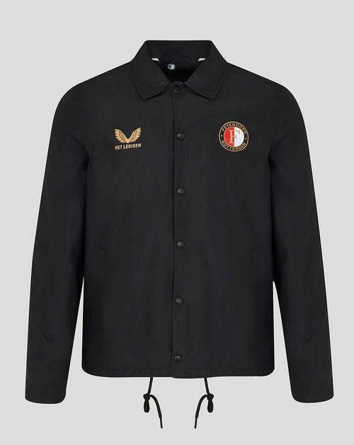 A black long-sleeve button-up jacket with a collar, featuring a gold embroidered winged logo and 'HET LAKEN' text on the right chest, and a circular red, white, and gold crest on the left chest. The jacket is displayed on a neutral light gray background.