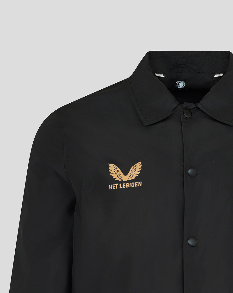 A close-up of a black collared button-up shirt with a gold embroidered winged logo and the text 'HET LEGIOEN' on the left chest, shown against a light gray background.