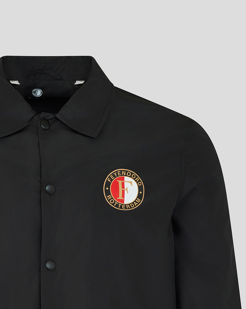 Close-up of a black collared button-up shirt with a circular embroidered logo on the left chest reading 'Feyeno Rotterdam Football Club' in red, white, and gold.
