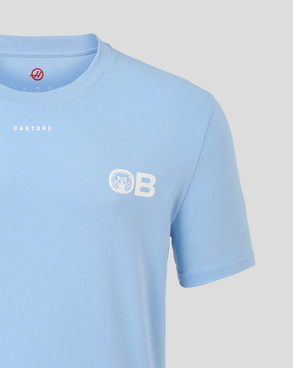 A light blue short-sleeve crewneck t-shirt by Castore, featuring a white 'OB' logo with a bear head emblem on the left chest and 'CASTORE' printed in white on the right chest, shown against a neutral light gray background.