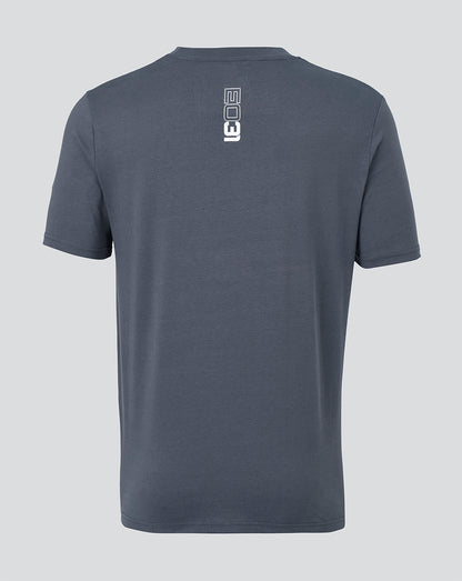 A dark slate blue-gray short-sleeve t-shirt shown from the back, featuring a vertical white graphic logo printed on the upper back.