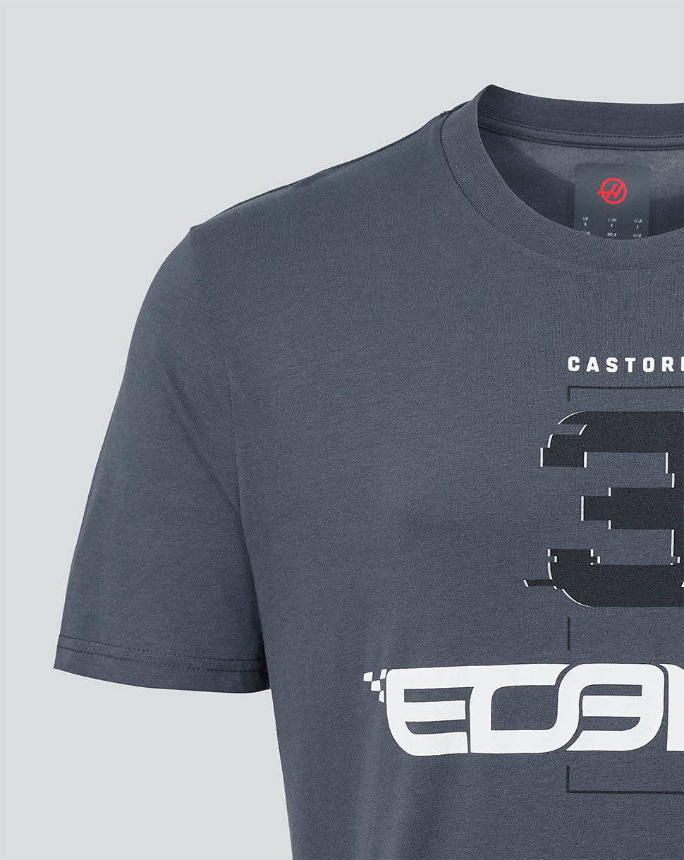 A close-up of a dark slate blue crewneck t-shirt featuring a large black and white graphic print on the front with the text 'CASTORE' and stylized lettering.