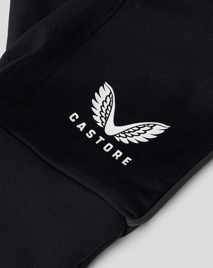 Close-up of white Castore logo on black fabric glove