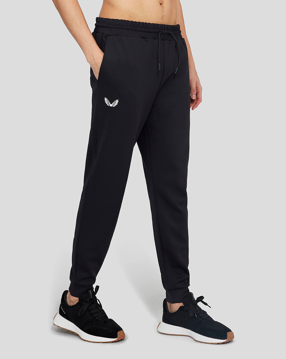 Onyx Flex Jogger black pants with drawstring waist and bold logo on the thigh, shown with sneakers.