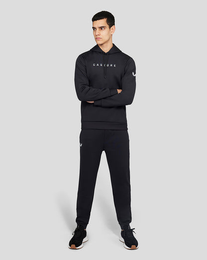 Male model in a full Onyx Flex Jogger set with a CASTORE hoodie bearing branding on the chest and a laurel logo on the sleeve.