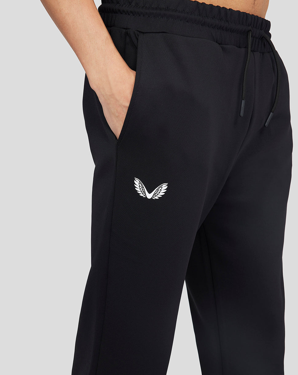 Onyx Flex Jogger in black with white wing logo at the hip and a hand in the pocket