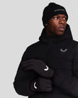 Male model wearing black Onyx Performance Gloves with white wing logo, paired with a black puffer jacket and knit beanie.