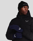 Model wearing navy Peacoat Performance Gloves with white wing logo and a black jacket.